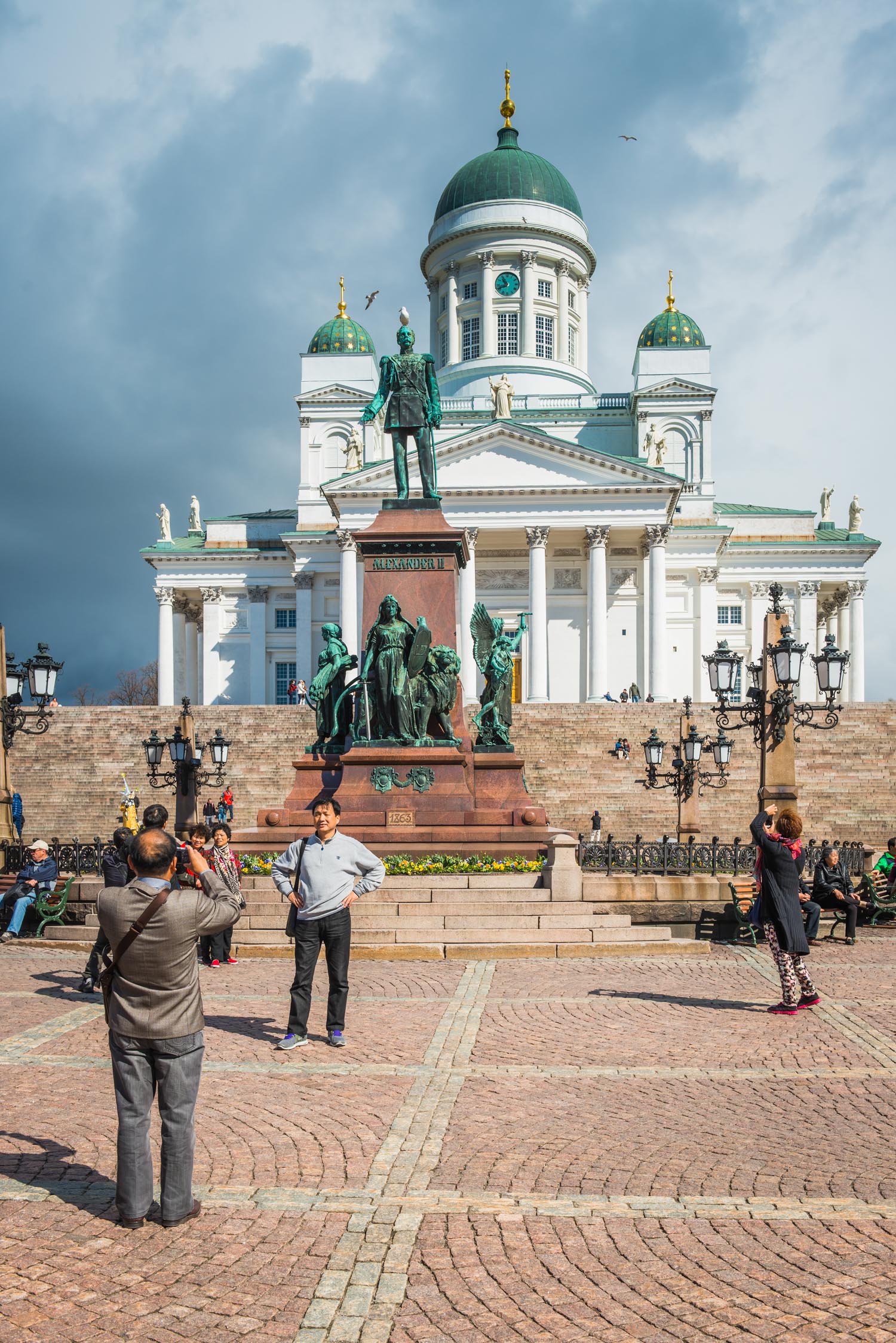 Helsinki tourists taking photographs in Senate Square of Cathedral Finland