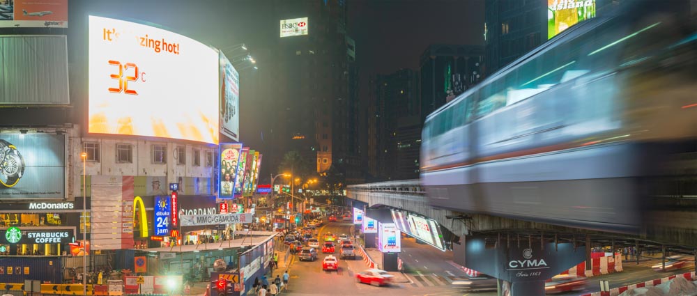 Kuala Lumpur Bukit Bintang monorail and crowded night cityscape panorama Malaysia
