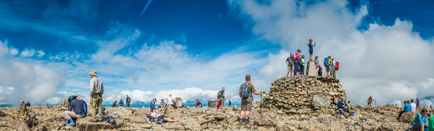 Scotland mountain hikers on summit of Ben Nevis Highlands peak panorama