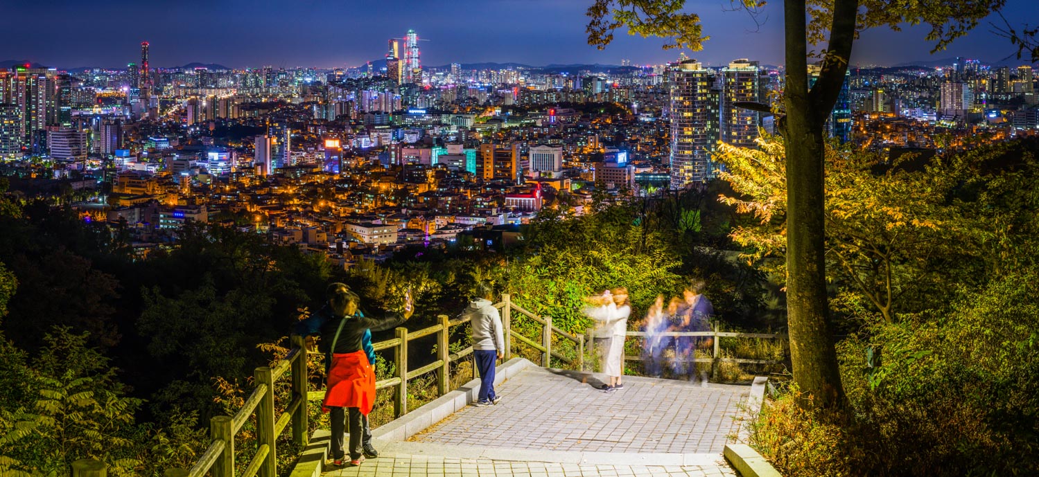 Seoul people taking photos on Namsan overlooking city night panorama