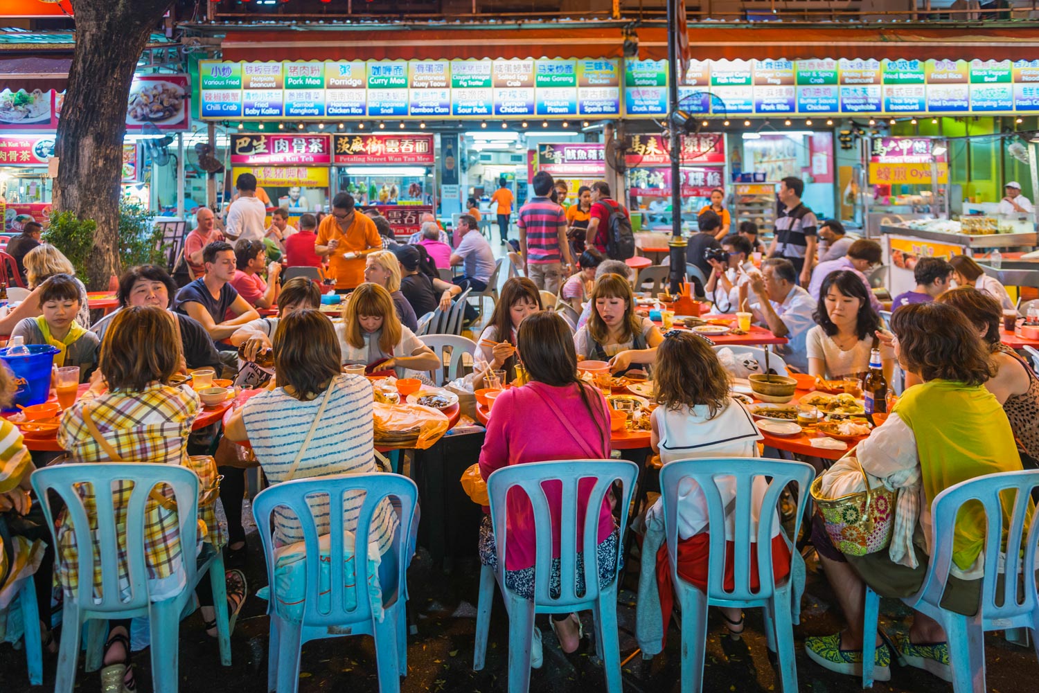 group of women at crowded outdoor restaurant Kuala Lumpur Malaysia